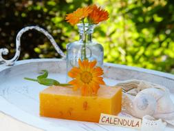 handmade Soap with Marigold flowers on tray outdoor