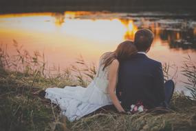 Bride and Groom near the water at sunset