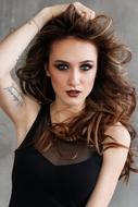 model with beautiful makeup and tattoos on the arm