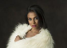 dark-skinned girl with a white fur cape