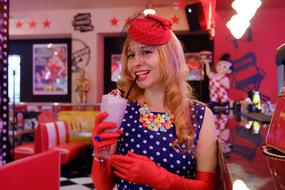 Colorful pin-up girl in American cafe