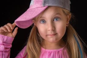 Girl in pink clothes on dark background