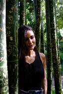beautiful brunette posing among the trees