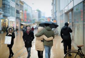 people walk down the street in the rain in Groningen