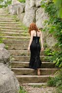 Woman with the ginger hair walking on the stairs