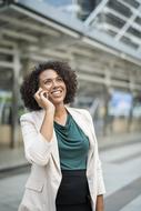 happy Businesswoman talking on phone on blurred background