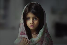 beautiful black-haired girl with a flower scarf on her head