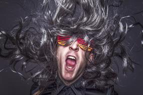 rock star in wig and glasses