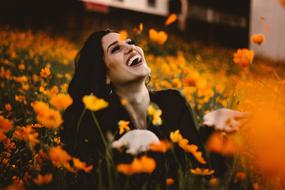 happy woman and Orange Flower Petals