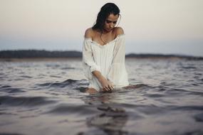 girl in a white dress in the ocean water