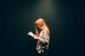 young woman reading magazine