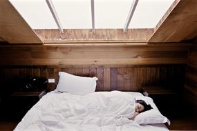 girl sleeping in a bed in the attic