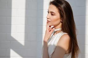Brunette Girl posing at wall