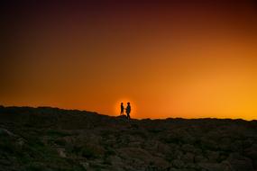 ASilhouette of the couple on the landscape with the light clipart