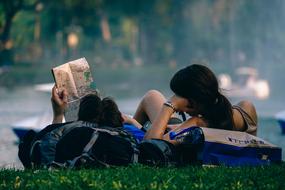 couple resting on a lawn in a park in Bangkok