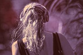 back view of long haired person with headphones