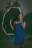 happy African woman with umbrella