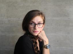 pensive girl with glasses and a long braid
