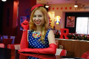 charming girl in 1950s clothes in a retro cafe in America