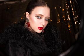photo of brunette in a black coat