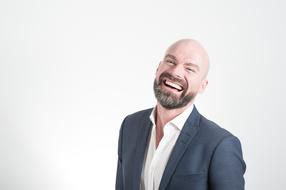 photo of a joyful bald businessman