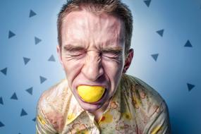 man with lemon in his mouth