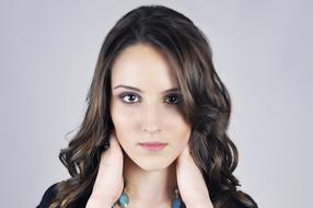 brunette is holding her neck