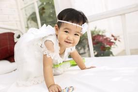 little girl in a white dress in a photo studio