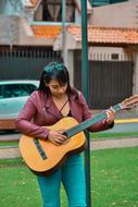 woman playing guitar outdoor