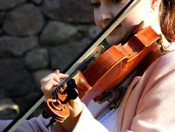 Violinist, young girl plays Violin outdoor