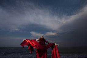 Woman in Red dress on shore