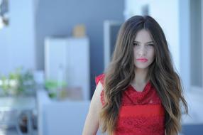 pensive girl in a red dress