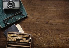 Old Wooden typescript and vintage camera on table