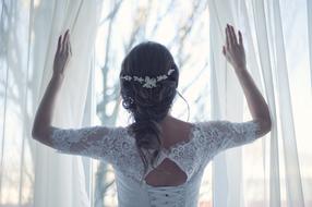 back view of Bride standing at window