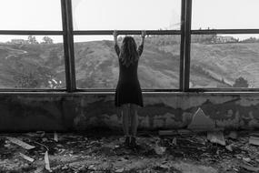 monochrome photo of girl on abandoned building