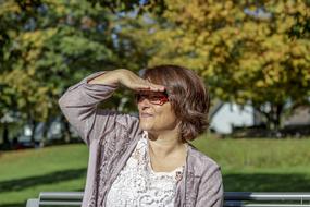 Woman on park bench, sun