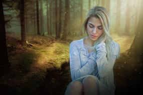 Beautiful woman in the forest under the sunshine