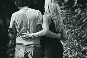 black and white photo of a couple in the park