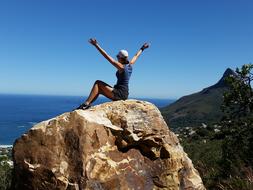 climbing woman sitting on the rock