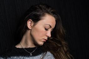 charming Young Girl with long Hair at black background