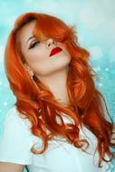 photo of red-haired girl on a blue background