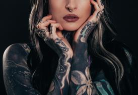 cool woman with Tattoos on Body at darkness