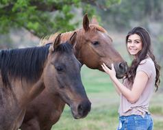 two Horses and happy young Girl outdoor