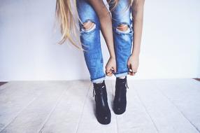 legs of a girl in jeans and leather shoes