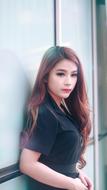 long haired beautiful Asian Girl posing at wall