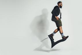 cool young man in Fashion clothing Balancing on Chair