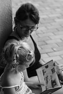 mother with daughter reading a book