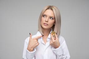 girl pointing to coin in her hand