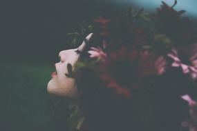 sensual Woman with flowers in hair at dusk