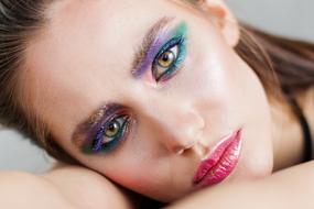 photo of a girl with bright green-purple makeup